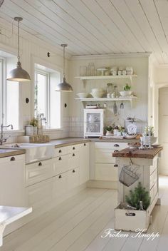 the kitchen is clean and ready to be used for cooking or baking, with white painted wood flooring