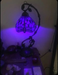 a purple lamp sitting on top of a table