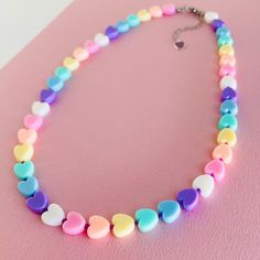 🌈 This adorable necklace features heart shaped acrylic plastic beads and Japanese glass seed beads with a 2 inch extension chain with cute heart drop. Metal components are stainless steel, tarnish free and hypoallergenic. 🌈💛 ⛓️Carefully crafted: each necklace handmade by me with care 📐Please note that size measurements are approximate: 16.5" + 2" EXTENSION CHAIN 🖥️  Kindly be aware that the color of the product in the photo may slightly differ due to variations in screen/monitor color displ Trendy Adjustable Heart Shaped Beaded Necklaces, Trendy Heart Beads Necklace For Gifts, Cute Multicolor Jewelry With Heart Charm, Cute Multicolor Jewelry With Heart Beads, Cute Multicolor Beaded Necklaces With Heart Beads, Cute Heart Pendant Necklace With Heart Beads, Trendy Adjustable Heart Beads Necklace, Cute Heart Shaped Necklace With Adjustable Chain, Trendy Heart Beads Necklace For Valentine's Day