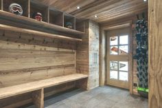 the inside of a cabin with wooden walls and shelves