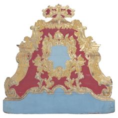 an ornate gold and red bed frame on a white background, with blue border around the edges