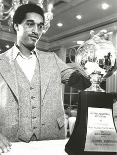 a man standing next to a trophy on top of a table