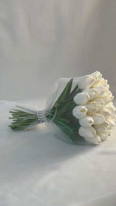 a bouquet of white tulips wrapped in plastic