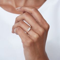 a woman wearing a diamond ring on her finger