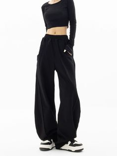 Embrace a touch of sophistication with our High-Waisted Wide-Leg Paneled Joggers, blending casual comfort with a polished finish.
  Crafted from 100% modified polypropylene fiber, these joggers offer a soft knit texture and a structured wide-leg silhouette. The high waist design is both flattering and practical, lending itself to a variety of versatile styling options.
  Perfect for an understated office look or a relaxed weekend outfit, pair these joggers with a fitted turtleneck and ankle boot Black Bottoms With Comfort Waistband For Fall, Black Comfort Waistband Bottoms For Fall, Stretch Wide Leg Pants For Streetwear, Comfort Stretch Solid Trousers, Relaxed Fit Bottoms With Elastic Side Panels, Straight Leg Bottoms With Elastic Side Panels, Solid Bottoms With Elastic Side Panels And Loose Hips, Comfort Stretch Black Bottoms With Pockets, Black Pants With Comfort Waistband And Loosely Fitted Hips