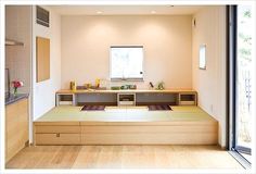 an empty room with wooden flooring and shelves on the wall next to sliding glass doors