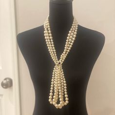 This Chanel Lavalier Necklace Is From The 2014 Autumn Pre-Fall, Metiers D’arts Collection. It Is Crafted With Several Strands Of White Faux Pearls And Champagne Gold-Toned Hardware. It Has A Lobster Clasp Closure That Hooks To An Adjustable Chain With A Dangling Cc Charm At The End. The Chain, Lobster Clasp And Cc Charm All Have A Textured Design. The Necklace Is Stamped On A Small Dangling Charm Near The Clasp: “Chanel B14 Cc A Made In Italy”. Can Be Adjusted By 3 Inches. Measurements: Length 25 In/ 63.5 Cm, Pendant Length: 6 In / 15.24 Cm This Is In Pristine Condition. Elegant Cream Jewelry For Evening, Glamorous Pearl Necklace For Formal Occasions, Elegant Lariat Pearl Necklace For Formal Occasions, Glamorous White Pearl Necklace For Evening, Luxury White Pearl Necklace For Party, Elegant Cream Pearl Necklace For Formal Occasions, White Pearl Necklace For Evening, Elegant White Necklaces For Vintage Events, White Lariat Pearl Necklace For Formal Occasions