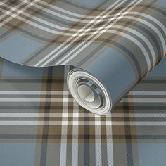 a blue and brown plaid wallpaper with a rolled up roll