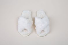 a pair of white slippers sitting on top of a table