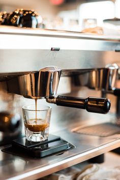 an espresso machine is being filled with liquid