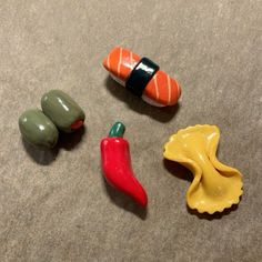 three different colored plastic toys sitting on top of a table