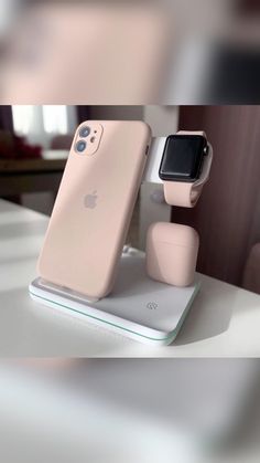 an apple watch and earbuds stand on a table