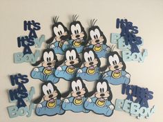 a bunch of mickey mouse magnets sitting on top of a white table next to each other