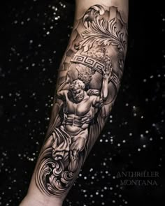 a man's arm with a tattoo on it and an image of jesus holding the cross