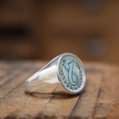 I call this ring "The Chase". It reads like a Coat of Arms for lovers and hopless romantics of all sorts. Ah..true love. It has a hidden message on the underside that reads "thinking of you" written in long hand.Built for comfort, this hefty sterling silver signet ring looks great on a pinky finger or wear it big and bold on your ring , middle or index finger.My original drawing is screen printed and fired on three layers of vitreous enamel at 1400 degrees making for a waterproof, durable and vi Classic Sterling Silver Enamel Ring For Anniversary, Sterling Silver Enamel Ring With Polished Finish As Gift, Classic Oval Enamel Ring For Gift, Gift Enamel Ring With Polished Finish In Sterling Silver, Gift Enamel Ring With Polished Sterling Silver, Engraved Enamel Anniversary Ring, Sterling Silver Hallmarked Enamel Ring As Gift, Symbolic Sterling Silver Initial Ring For Wedding, Hallmarked Enamel Ring As Fine Jewelry Gift