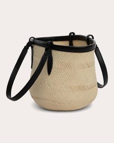 Handcrafted from natural Iraca de palma leaves, Hunting Season's basket tote is expertly woven to create a textural, round appearance. The small silhouette is topped with slim handles and topstitched leather trim for a sleek, elevated look. No closure Nappa leather contrast Topstitched details Interior slip pocket Unlined Outer: 90% natural iraca fiber, 10% leather Store in dust bag Iraca fiber sourced from Colombia Made in Spain Measurements Width: 8.6in Height: 7.8in Depth: 4.7in | Hunting Season Women's The Iraca Small Basket Tote in Black | Leather Leather Store, Basket Tote, Small Basket, Hunting Season, Nappa Leather, Leather Trim, Leather Trims, Dust Bag, Black Leather