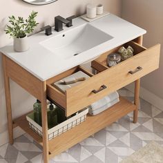 a bathroom sink sitting under a mirror next to a wooden cabinet with drawers underneath it