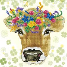 a cross stitch cow with flowers on it's head