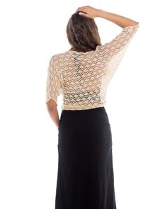 The Knitted Bolero Motiv features an iridescent mother of pearl shell button closure. The body of this bolero is triangle shape with mid length sleeves and a pointed back hem. This crochet piece envelopes whatever you choose to wear underneath it and the detail on it is easily dressed up or down. It lays close to the body and sits at or above the waistline. It's breathable with wonderful airflow and is a perfect item to travel with as it can be worn in many situations. It is made of a super soft Elegant Fitted V-neck Shrug, Elegant Fitted Cardigan With Short Sleeves, Elegant Crochet Top With Open Knit V-neck, Elegant Fitted Open Knit Cardigan, Elegant Stretch Crochet Top For Party, Elegant V-neck Open Knit Crochet Top, Chic Fitted 3/4 Sleeve Shrug, Elegant V-neck Fitted Shrug, Fitted Open Knit Party Top