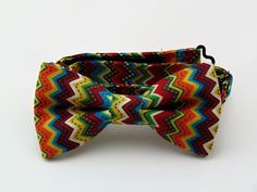 "Mens pre-tied Cinco De Mayo bow tie. Features a Mexican pattern with colors of red, green, orange, blue and yellow.  Pocket Square available upon request pending available of fabric. Cost is $10.99 Convo me to check availability. Pre-tied expertly hand-made from 100% cotton Bow Measures Approximately 4\"x 2.25\". You can select your length from (Boy's 11\" - 16\"), (Men's 14\" - 18\"), (Extra-long 16\" - 22\"). Custom sizes available upon request. Ships within 2 business days. Made in the USA. CUSTOM ORDERS We love custom orders, so you can also go to www.Fabric.com to select from one of their thousands of cotton fabrics and we can make a tie or bow tie for you. These requests will take at least 2 weeks to fulfill. Any Questions about this tie, custom orders or bulk quantities, simply hit Multicolor Bow Tie For Summer Gift, Fitted Multicolor Bow Tie For Gift, Multicolor Bow Tie For Gift, Yellow Pocket Square, Mexican Pattern, Make A Tie, Long Bow, Tie Men's, Mens Bow Ties