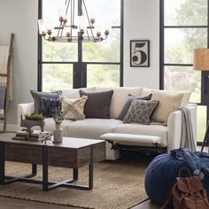 a living room filled with furniture and lots of windows