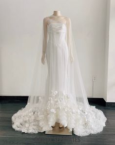 a white wedding dress on display in a room