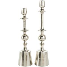 two silver candlesticks sitting next to each other