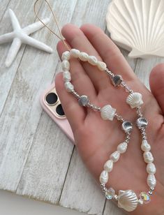 Summer Beach Pearl Shell Necklace, Pearl Shell-shaped Necklace For Beach, Silver Shell For Beach With Ocean-inspired Style, Shell-shaped Pearl Charm For Beach, Silver Shell Necklace For Summer Vacation, Silver Strand Shell Necklace For Beach, Beaded Shell For Beach Season, Ocean-inspired Pearl Shell For Beach, Ocean-inspired Shell With Pearl Charm For Beach