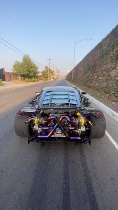 a car that is sitting on the side of the road with its engine in it's trunk