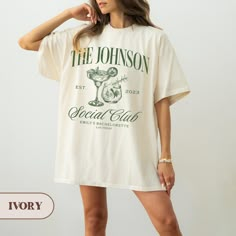 a woman wearing a white t - shirt with the words, the johnson social club on it