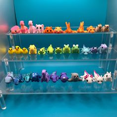 several plastic pokemon figurines are on display in a clear case with blue background