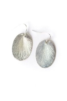 The brushed silver findings in a simple oval design. They are created with brushed silver plated brass, and dangle at approximately 1.25" from sterling silver ear wires. Silver Plated Brass (nickel and lead-safe) 1.25", with sterling silver ear wires We hand select our natural materials, thus there may be slight variations in color and/or size that will not detract from the overall aesthetic Our unique handcrafted designer jewelry for women is made in America, each design created individually in Sterling Silver Oval Pendant Earrings In Silver, Silver Oval Earrings With Lever Back Ear Wires, Silver Oval Earrings With Ear Wire, Floyd Va, Designer Handmade Jewellery, Simple Earrings, Designer Jewelry, Ear Wires, Natural Materials