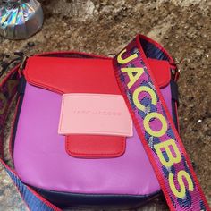 This Marc Jacobs Satchel Bag Is In Awesome Colors And Definitely Speaks For Itself Can Be Worn As A Satchel Or Crossbody From The Kids Line But Can Be Worn Creatively By Adults Free Top To Match In Requested Size Rectangular Shoulder Bag With Logo Strap For Shopping, Daily Use Tote Shoulder Bag With Logo Strap, Daily Use Shoulder Bag With Logo Strap Tote, Travel Bags With Branded Hardware In Multicolor, Multicolor Travel Bags With Branded Hardware, Satchel Bag With Logo Strap, Trendy Crossbody Shoulder Bag With Logo Strap, Daily Use Tote Bag With Logo Strap, Blue Rectangular Shoulder Bag With Logo Strap