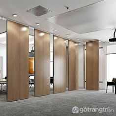 an office with sliding doors and chairs in the middle of it, surrounded by carpeted flooring