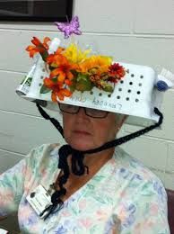 an older woman wearing a plastic hat with flowers on it