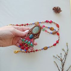 Bright pendant. Embroidered with beads and natural stones. Beautiful necklace. The inside is made of genuine leather.  Holiday accessory.  Can be an unusual gift The pendant can be paired with Egyptian-style earrings https://www.etsy.com/listing/1334551463/egyptian-earrings-embroidered-ethnic?click_key=a8fc11c3c19248eb231b68534e917b840e8d7bf1%3A1334551463&click_sum=cb9f4ba2&ref=shop_home_active_1&frs=1 Scarab pendant https://www.etsy.com/listing/1295039485/scarab-beetle-pendant-beaded-necklace?click_key=c16fb7719af6babca3ac7f2d3fb05604bb5c3ea9%3A1295039485&click_sum=4c38c71c&ref=shop_home_active_19&frs=1 Bohemian Beaded Chain Gems And Cabochons For Gifts, Handmade Artisan Beads, Gems, And Cabochons For Gifts, Handmade Artisan Beads Gems And Cabochons For Gifts, Bohemian Brown Beads Gems And Cabochons For Gifts, Bohemian Brown Beads And Cabochons For Gifts, Bohemian Beaded Chain For Crafts And Gifts, Bohemian Brown Beads Gems For Gifts, Bohemian Beaded Chain For Gift, Handmade Multicolor Amulet Beads And Cabochons