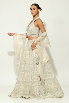 Ivory lehenga featuring floral motifs embellished by pearls, sequin and zircons on a shimmer base. Comes with padded bead embellished tasselled blouse and ruffle dupatta. - Aza Fashions Off-white Georgette Anarkali Set For Wedding, Elegant White Choli For Reception, Festive Off White Lehenga With Cutdana, Wedding Sharara In Off White With Pallu Detail, Party White Lehenga With Chikankari Embroidery, Off White Sharara With Sheer Dupatta For Reception, Off White Cutdana Lehenga For Eid, Off-white Cutdana Lehenga For Eid, Elegant Beige Choli For Diwali