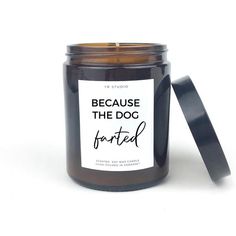 a candle with a label on it that says because the dog is tarted in black