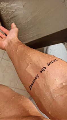 a man's arm with writing on it