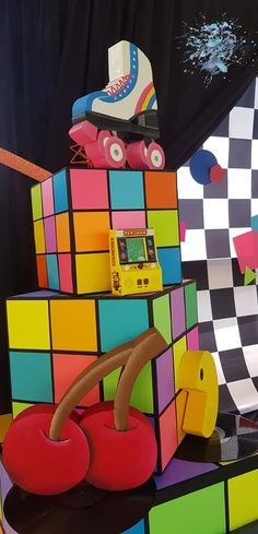 an assortment of colorful toys on display in a room with black and white checkered walls