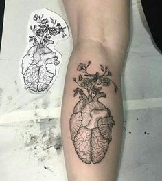 a person with a tattoo on their arm that has a flower in the shape of a heart