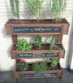 a wooden planter filled with lots of plants