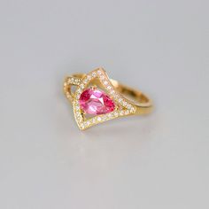 •Condition: Brand new•Center Stone: Natural Pink Peach Sapphire, Pear Shape, approx 0.79ct•Side stones: Natural white diamond round-cut (VS1 clarity and F color)•Ring Weight: 3.08ct•Metal Purity: Optional Each piece is made-to-order with care and special attention to detail. all items are made with conflict-free diamonds and gems.Size: made to orderThe item will be gift wrapped and shipped.-------------------------------------------------------------------Available in :14k Rose or Yellow Gold, W Pink Sapphire Rings With Pave Setting For Gift, Pink Sapphire Pave Setting Ring For Gift, Gold Pink Sapphire Ring With Brilliant Cut, Pink Sapphire Pave Wedding Jewelry, Anniversary Pink Sapphire Rings With Pave Setting, Wedding Ring With Pink Sapphire And Pave Setting, Gold Sapphire Ring With Pave Setting For Wedding, Wedding Rings With Pave Setting And Pink Sapphire, Pink Sapphire Wedding Rings With Pave Setting