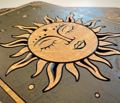 the sun and moon are carved into wood