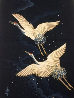 two white cranes flying through the night sky