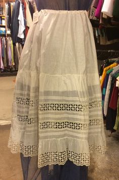 This beautiful, antique, original 1880s Victorian skirt/petticoat features hand-sewn details and lace along the hemline. Adjustable drawstring waist, and designed for adjustable length by folding the fabric up mid-skirt and sewing into place.  Currently measures 30.5", with an additional 2" possible. This is in excellent condition, but we are selling it as-is, so please be aware that this does have very minor wear, and because it is well over 100 years old, is a delicate yet beautiful piece of h Vintage Long Ruffled Petticoat, Victorian Skirt With Ruffles, Vintage Petticoat With Attached Cancan For Summer, Vintage Long Skirt Petticoat, Vintage Long Lace Skirt, Vintage Lace Skirt With Lace Patchwork, Vintage Lace Petticoat With Ruffles, Vintage Lace Petticoat For Summer, Vintage Long Skirt With Attached Cancan