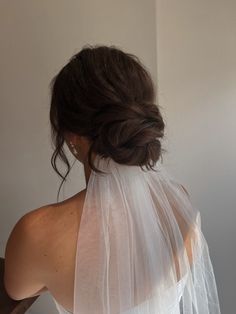 the back of a bride's head wearing a white veil