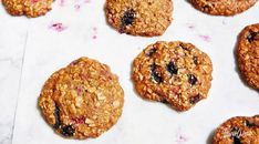 several oatmeal cookies sitting on top of a white countertop next to each other