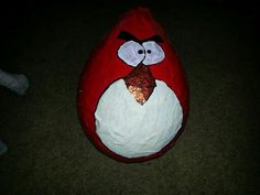 an angry bird stuffed animal sitting on the floor