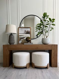 a table with two stools and a mirror